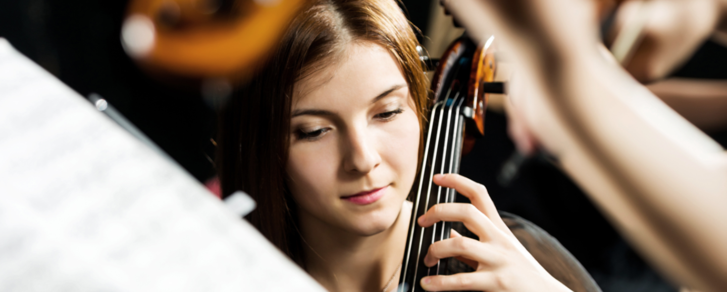 Violinist playing amongst an orchestra