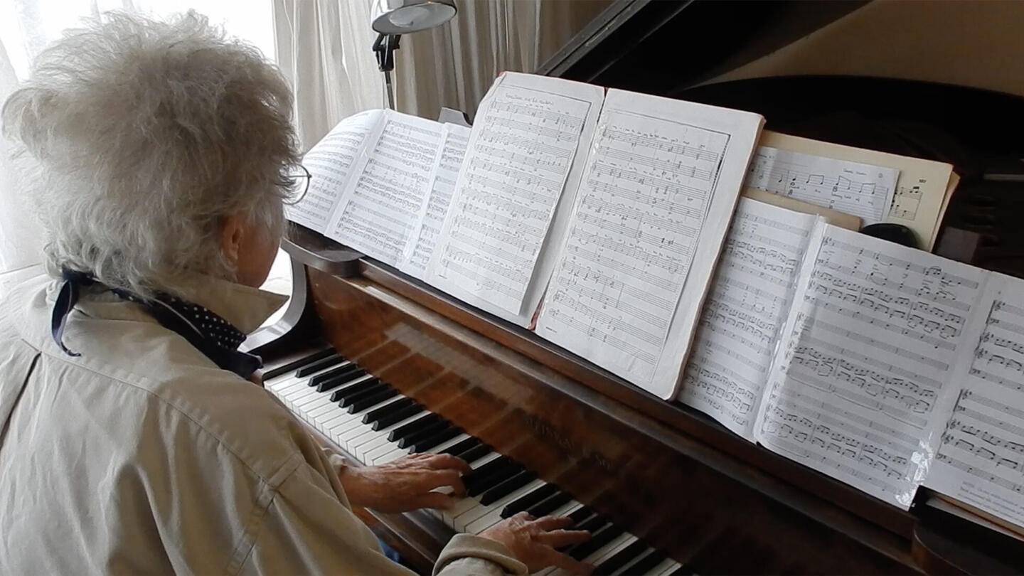 Lady playing a grand piano