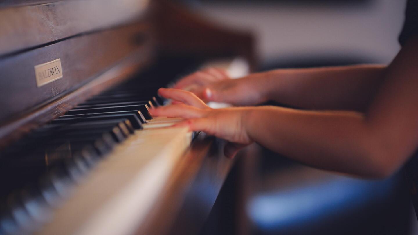 A young musician playing the piano